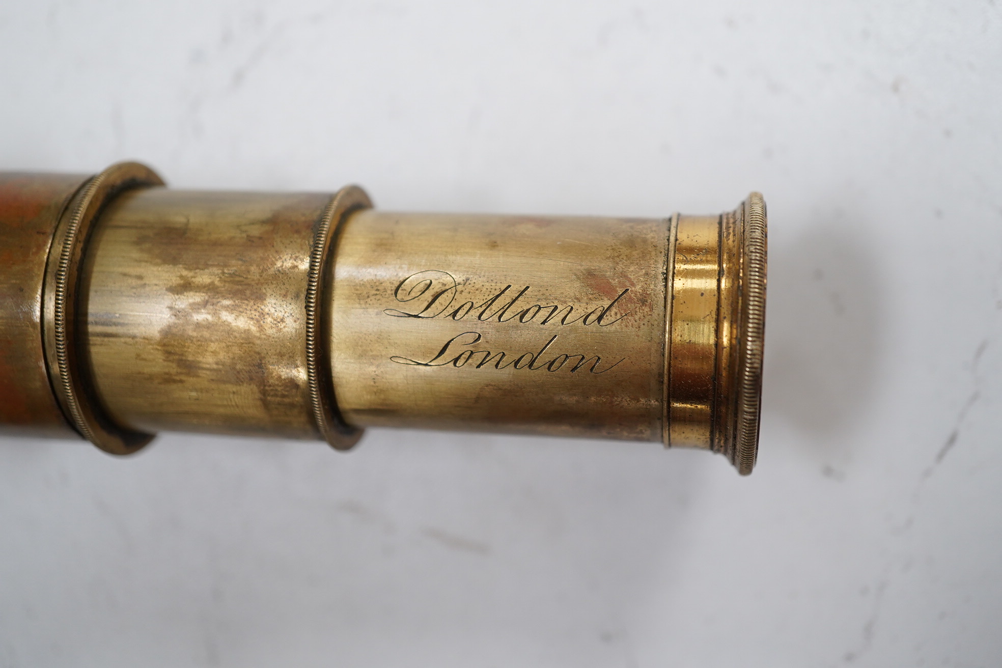 A leather cased Dolland three draw telescope, 72cm fully drawn. Condition - fair considering use